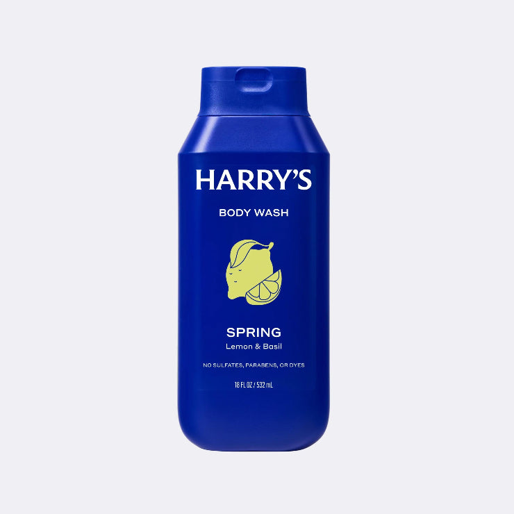Blue bottle of Harry's body wash with lemon and basil illustration on a light gray background