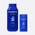 Blue bottles of Harry's body wash and deodorant on a light gray background
