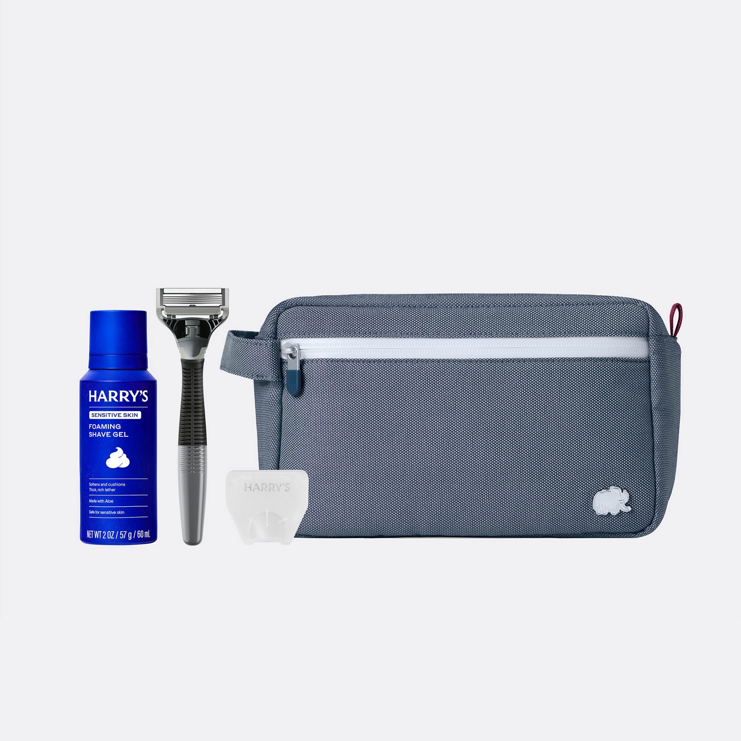 Grooming kit with Harry's shaving gel, razor, and pouch on a white background