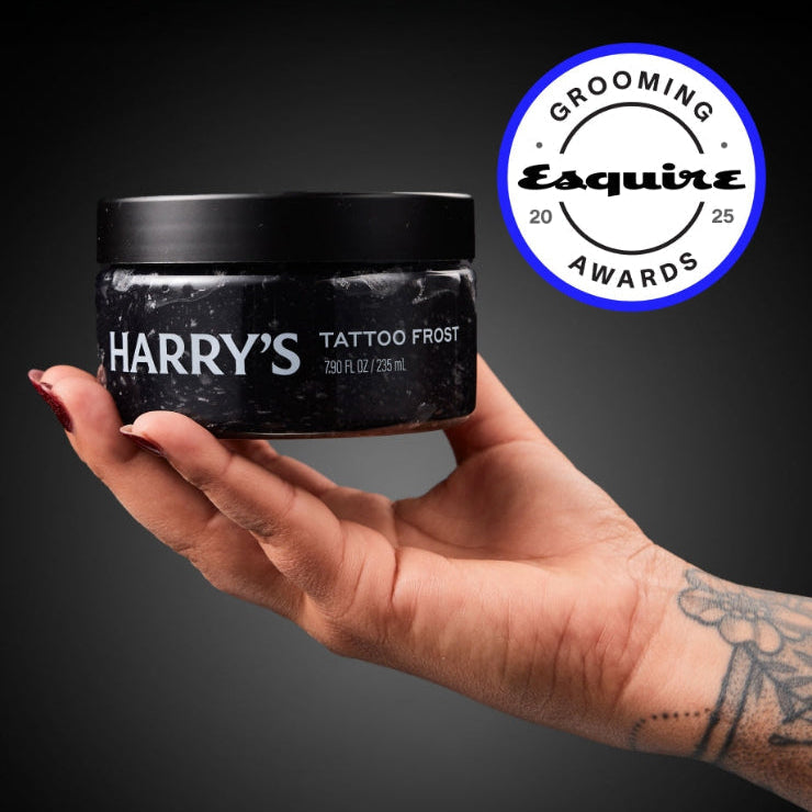 Hand holding a jar of 'Harry's Tattoo Frost' with Esquire Grooming Awards logo.