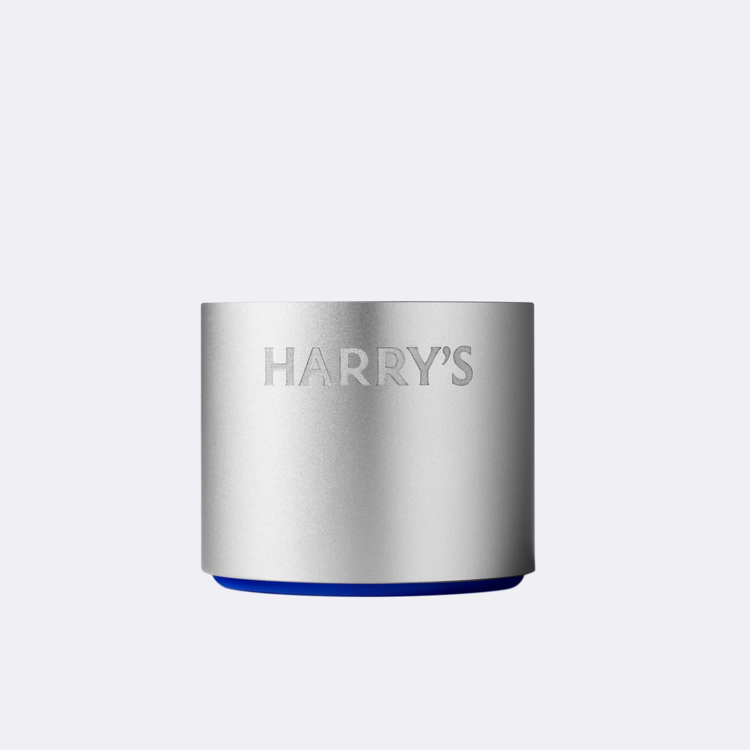 Silver cylindrical razor stand with 'HARRY'S' branding on a light gray background
