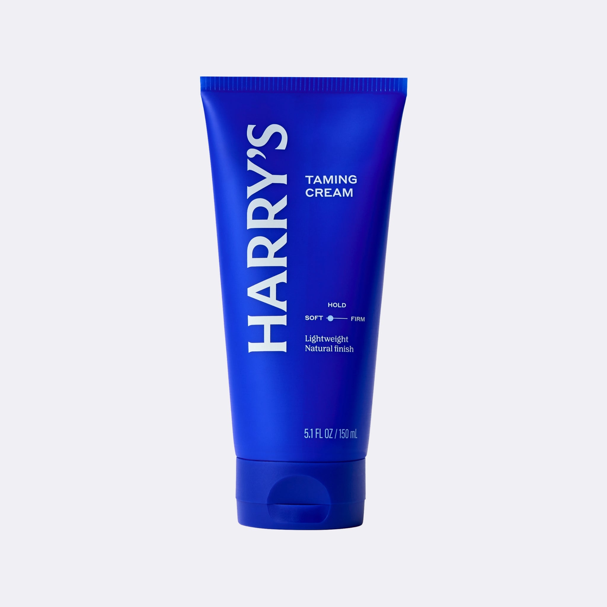 Blue tube of Harry's taming cream on a white background
